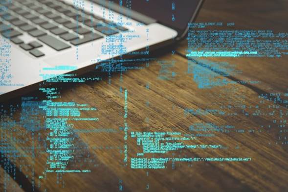 Código de programación con portátil de fondo